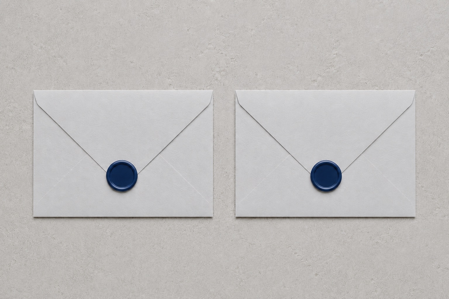 Two identical sealed envelopes lying side by side on a pale stone surface, each closed with the same unmarked navy wax seal, indistinguishable from one another
